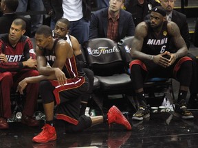 Members of the Miami Heat watch from the bench during the fourth quarter of their blowout loss against the San Antonio Spurs on Sunday. (USA TODAY SPORTS)