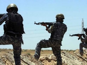 Members of the Iraqi security forces patrol an area near the borders between Karbala Province and Anbar Province, June 16, 2014.  REUTERS/ Mushtaq Muhammed