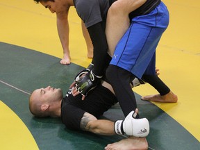 Mitch Gagnon seen on the bottom teaches a few moves to local fighters.