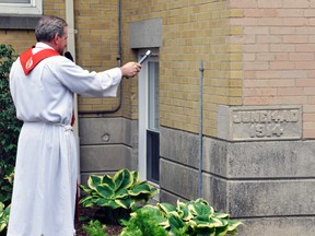 Fr. Moe Charbonneau (left), former Pastor of St. Patrick’s Parish in Dublin, gave the commemorative blessing of the office cornerstone. Fr. Charbonneau was a surprise guest who con-celebrated the anniversary service. ANDY BADER/MITCHELL ADVOCATE
