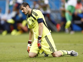 Spain goalkeeper Iker Casillas reacts after a goal by the Netherlands during their World Cup match at the Fonte Nova arena in Salvador June 13, 2014. (REUTERS/Marcos Brindicci)