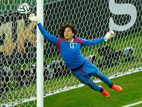 Mexico's Guillermo Ochoa jumps to save the ball during their World Cup match against Brazil at the Castelao arena in Fortaleza, Brazil on Tuesday, June 17, 2014. (Mike Blake/Reuters)
