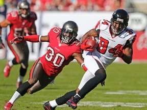 Falcons wide receiver Roddy White (right) eludes Buccaneers cornerback LeQuan Lewis in 2012. Lewis, who was released by the Cardinals last month, is in camp with the Argos. (Reuters)