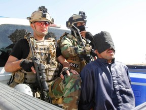 Personnel from the Kurdish security forces detain a man suspected of being a militant belonging to the al Qaeda-linked Islamic State in Iraq and the Levant (ISIL) in the outskirts of Kirkuk June 16, 2014. (Reuters)