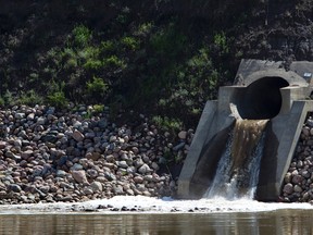 A storm drain flows into the North Saskatchewan river in Edmonton, Alta. on  Thursday, June. 13, 2013. Edmonton Sun
