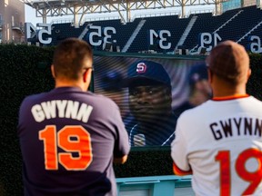 Fans watch highlights at a makeshift memorial to former San Diego Padres outfielder Tony Gwynn at Petco Park in San Diego on Tuesday. (Sam Hodgson/Reuters)
