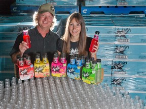 Rob Kelly and Cathy Siskind-Kelly of Black Fly Beverage Co. are happy to announce their new flavour for 2014 is Rum Punch. Their micro-distillery on Sovereign Road is now outfitted with machinery to make its own plastic bottles, which are dropped into the production line just in time to be filled. (DEREK RUTTAN/ The London Free Press)