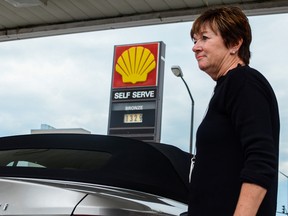 Kim McCord fills up at a Kingston gas station. (Alex Pickering/For The Whig-Standard)