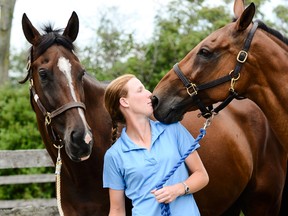 Selena O’Hanlon stands with two of her horses, Foxwood High, left, and Colombo. (Corey Lablans For The Whig-Standard)