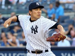 New York Yankees starting pitcher Masahiro Tanaka pitches during the first inning against the Toronto Blue Jays at Yankee Stadium on June 17, 2014. (Anthony Gruppuso/USA TODAY Sports)