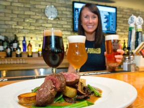 Candace Thody offers up a trio of beers, a Cheshire Valley Robust Porter, a Bellwoods Cat Lady IPA and Forked River Brewing Company Riptide Rye, which pair well with steak frites, at Milos? Craft Beer Emporium in London. (CRAIG GLOVER, The London Free Press)