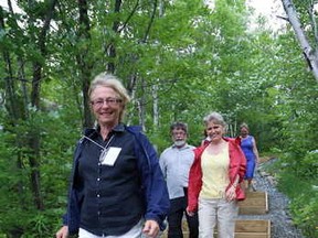 Ursula Sauve, front, president of Rainbow Routes Association, Al MacPherson, chair of Trans Canada Trail Ontario and Deborah Apps, president and CEO of Trans Canada Trail walk last month on the newest section of the Trans Canada Trail at Lake Laurentian Conservation Area in Sudbury.