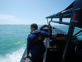 A Malaysia Maritime officer looks out into the sea during a search and rescue in Kuala Langat outside Kuala Lumpur, off Malaysia's western coast, June 18, 2014. (REUTERS/Samsul Said)