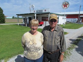 Barbara and Gordon Leaper stand outside an old fashion gas station the family created on its farm on Moore Line, near Brigden. The Leaper Farm, and its collection of antique cars, tractors and memorabilia, is part of the Doors Open Lambton event, June 21 and 22. PAUL MORDEN/ THE OBSERVER/ QMI AGENCY
