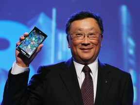 BlackBerry chief executive John Chen holds a Blackberry Z3 during a launch event in Jakarta, May 13, 2014. REUTERS/Beawiharta