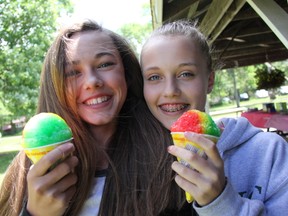 Haley Barclay and Morgan Patterson enjoy summer treats at the June 14 Poplar Hill picnic. ELENA MAYSTRUK/ AGE DISPATCH/ QMI AGENCY