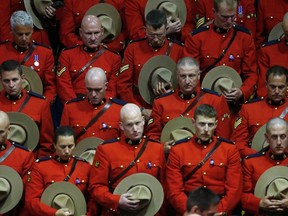 RCMP officers attend the regimental funeral for three fellow officers who were killed last week in Moncton, N.B., on June 10, 2014. (REUTERS/Christinne Muschi)