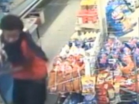 A security video image shows the suspect in a gunpoint store robbery on June 2 along Third Ave. in The Glebe. The bandit tries to rob the store, but is chased off when the owner grabs a broom and begins fighting him. (Screengrab via Ottawa Police / YouTube)