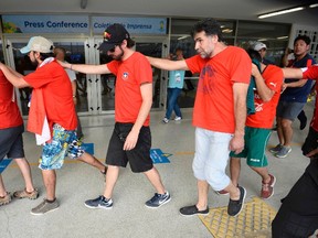 Chile fans are escorted by police after dozens of them crashed a gate to enter Maracana Stadium before Wednesday’s World Cup game against  Spain in Rio de Janeiro. (REUTERS/Dylan Martinez)