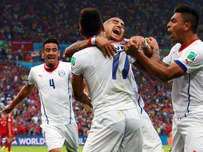 Chile's Mauricio Isla (left to right), Eduardo Vargas, Arturo Vidal and Gonzalo Jara celebrate after scoring against Spain during their World Cup Group B match at Maracana Stadium in Rio de Janeiro, Brazil, June 18, 2014. (JORGE SILVA/Reuters)