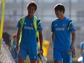 Japan's national soccer team players Hiroki Sakai (L) and Gotoku Sakai walk towards the pitch before the training session at Japan's team base camp in the town of Itu north-west of Sao Paulo June 17, 2014.  (REUTERS/Maxim Shemetov)