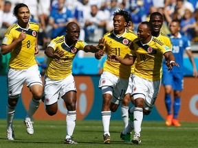 Colombia's Pablo Armero (second left) celebrates his goal against Greece with his teammates during their World Cup match at the Mineirao stadium in Belo Horizonte, Brazil on Saturday, June 14, 2014. (Sergio Perez/Reuters)