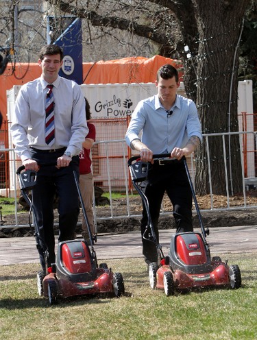 Mayor Don Iveson and Edmonton OIler Andrew Ference mows the grass at City Hall in Edmonton, Alberta on Monday, May 12, 2014.  The city wants to encourage homeowners to go bagless when they cut their grass.   Perry Mah/ Edmonton Sun/ QMI Agency