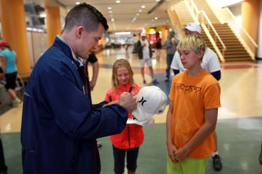 Andrew Ference signs some autographs for Triniti (c) and David (r) Martens. The brother and sister are from Bristish Columbia and are attending Oilers Hockey School.New Edmonton Oiler Andrew Ference speaks to the media at Servus Place In St Albert, Alberta on Tuesday, July 16, 2013 Perry Mah/Edmonton Sun/QMI Agency