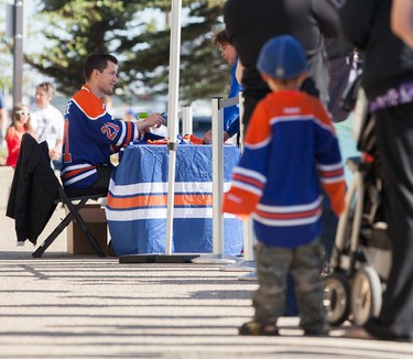 Edmonton Oilers' Andrew Ference signs autographs, outside of Rexall Place, on Saturday before the locker room sale began in Edmonton, Alberta on June 7th, 2014.  Chad Steeves/ Edmonton Sun/ QMI Agency