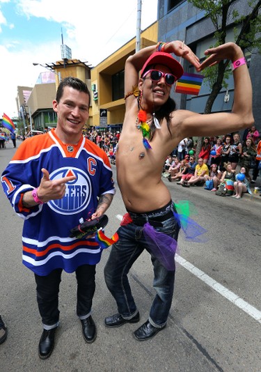 Edmonton Oilers captain Andrew Ference (L) psoes fopr a photo with Boyd Whiskeyjack as he marched in the Pride Parade in downtown Edmonton, Alta., on Saturday, June 7, 2014. Perry Mah/Edmonton Sun/QMI Agency