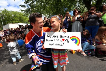 Edmonton OIlers' Andrew Ference chats with 7 year old Justise  Maeff during the Pride Parade in downtown Edmonton, Alta., on Saturday, June 7, 2014.  Perry Mah/Edmonton Sun/QMI Agency
