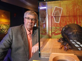 Minister of Environment and Sustainable Resource Development Robin Campbell is seen with a 400x pine beetle model at an announcement of pine beetle populations for the province of Alberta at Telus World of Science Edmonton in Edmonton, Alta., on Wednesday, June 18, 2014. Both good and bad news were announced in the fight against the voracious insect. Ian Kucerak/Edmonton Sun