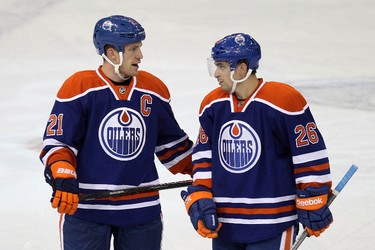 Edmonton Oilers captain Andrew Ference (21) speaks with Mark Arcobello (26) during the second period of play against the Winnipeg Jets at Rexall Place in Edmonton, Alta., on Tuesday, Oct. 1, 2013. Ian Kucerak/Edmonton Sun/QMI Agency