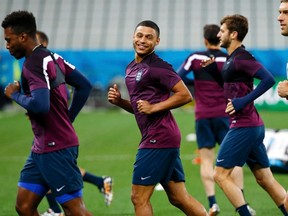 England's national soccer team player Alex Oxlade-Chamberlain (C) smiles as he and teammates attend their final practice one day before the match against Uruguay, in Sao Paulo June 18, 2014.   (REUTERS/Damir Sagolj)