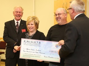Gino Donato/The Sudbury Star
Mario Palin and his wife Donna of Sudbury,were presented with a cheque for $250,000 won in the Knights of Columbus Ontario Charities Foundation draw on Wednesday night at St. Andrew's Church on Barrydowne Road. Presenting the cheque is state deputy Kevin Daudlin, right, and state treasurer Peter Lemon. The foundation supports many charities throughout the province with the main recipient being the Arthritis Society.
