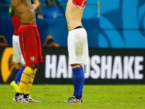 Cameroon's Stephane Mbia (left) and Croatia's Ivan Rakitic exchange jerseys after their World Cup match at the Amazonia arena in Manaus, Brazil on Wednesday, June 18, 2014. (Murad Sezer/Reuters)