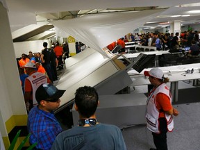 A view of overturned furniture and partition walls in the press room of the Maracana stadium after dozens of Chile fans stormed through to watch their country play Spain in a 2014 World Cup Group B soccer match in Rio de Janeiro, June 18, 2014. (REUTERS/Ricardo Moraes)