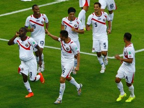 Costa Rica's Joel Campbell (9) celebrates with teammates after scoring a goal against Uruguay during their 2014 World Cup Group D soccer match at the Castelao arena in Fortaleza June 14, 2014. (REUTERS/Mike Blake)