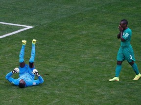 Ivory Coast's Boubacar Barry (L) and Arthur Boka react after Colombia's Juan Quintero (not pictured) scored during their 2014 World Cup Group C soccer match at the Brasilia national stadium in Brasilia June 19, 2014. (REUTERS/David Gray)