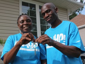 Riziki Maua and Esengi Songolo show off the keys to their new Maple Avenue home Thursday. More than 150 Sarnia-Lambton young adults helped build the Habitat for Humanity home over the last eight months. BARBARA SIMPSON/THE OBSERVER/QMI AGENCY