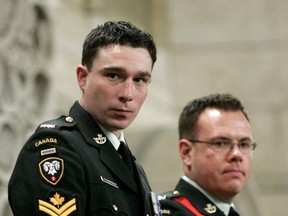 Collin Fitzgerald (L) and Patrick Tower stand to be recognised in the House of Commons on Parliament Hill in Ottawa in this 2007 file photo. Fitzgerald was presented with the Medal of Military Valour and Tower with Star of Military Valour. Fitzgerald was back in court on Tuesday.
Chris Wattie/REUTERS/File photo