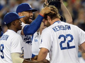Los Angeles Dodgers starting pitcher Clayton Kershaw (22) celebrates  with left fielder Matt Kemp (27) and second baseman Dee Gordon (9) after the final out of his no-hitter against the Colorado Rockies at Dodger Stadium on Jun 18, 2014 in Los Angeles, CA, USA. (Jayne Kamin-Oncea/USA TODAY Sports)