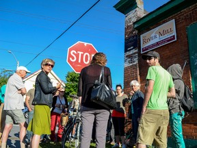 Supporters gather outside the former Bailey Broom Company building to protest its planned demolition. (Alex Pickering/For The Whig-Standard)