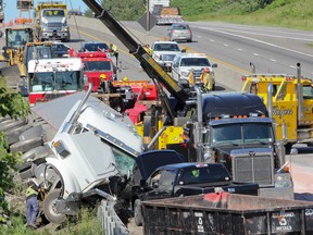 A collision between a tractor-trailer and Volkswagen Golf had the westbound lane of Hwy. 401 closed for most of the afternoon on Thursday. (Julia McKay/The Whig-Standard)