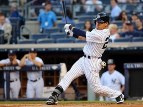 New York Yankees center fielder Jacoby Ellsbury (22) hits a sacrifice fly allowing left fielder Brett Gardner (not pictured) to score during the first inning against the Toronto Blue Jays at Yankee Stadium on Jun 19, 2014 in Bronx, NY, USA. (Anthony Gruppuso/USA TODAY Sports)