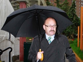 Alberta PC leader candidate Ric McIver leaves a media availability opportunity after speaking to media on Thursday June 19, 2014 in Calgary, Alta about his recent participation in a controversial group's march. Jim Wells/Calgary Sun/QMI Agency