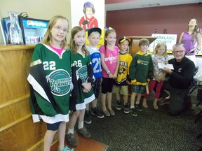 KidSport Parkland chair Peter Morris (right) accepts a donation from these young athletes, who worked hard making elastic band bracelets after school for three months. After selling their bracelets, the kids raised an impressive $1,250. - Caitlin Kehoe, Reporter/Examiner