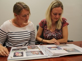 Stephanie Nethery, right, and her sister Jessica's best friend Shannon Turner look through a family photo album. (Observer file photo)