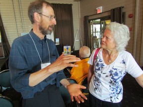 Chris Smart, a Western University geography professor, speaks with Sharon Roppel from the Port Elgin area, following Smart's presentation Friday in Grand Bend at a Lake Huron Centre for Coastal Conservation conference. PAUL MORDEN/THE OBSERVER/QMI AGENCY