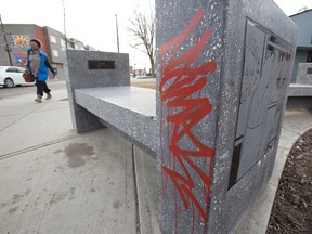Graffiti is seen on a bench along 118 Avenue near 92 Street in Edmonton, Alta., on Monday, April 14, 2014. Two men, Garrett Morin, 25, and Kordell Cardinal, 18, are facing 160 graffiti-related charges by the Edmonton Police Service for tagging. Ian Kucerak/Edmonton Sun